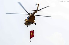 组图：悬挂国旗的越南战斗机和直升机在河内上空举行空中演习