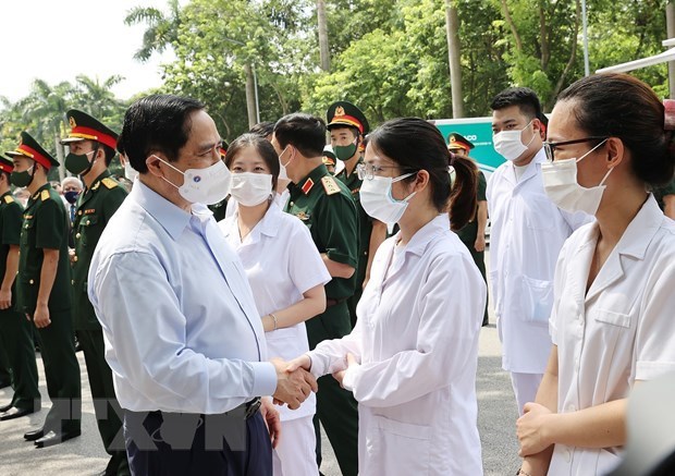 越南政府总理范明政：许多人希望优先为疫情重灾区进行新冠疫苗接种 hinh anh 1