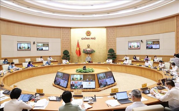 越南政府总理范明政：研究安全、灵活适应和有效控制疫情措施 hinh anh 1