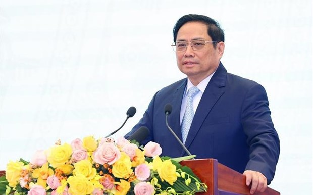 越南政府总理范明政：使人民和企业成为立法和执法工作的中心和主体 hinh anh 1