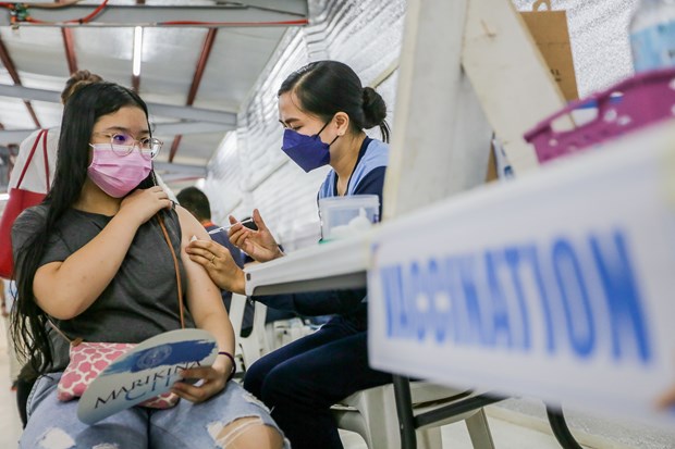 老挝自2022年1月起试点开学复课 菲律宾批准为5 - 11 岁儿童接种新冠疫苗 hinh anh 1