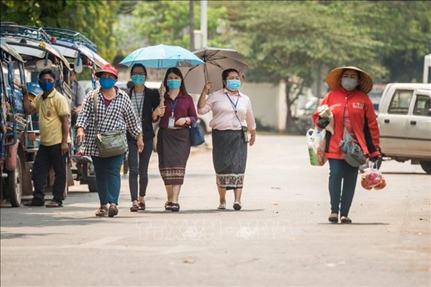 老挝建议民众继续坚持防疫措施 hinh anh 1