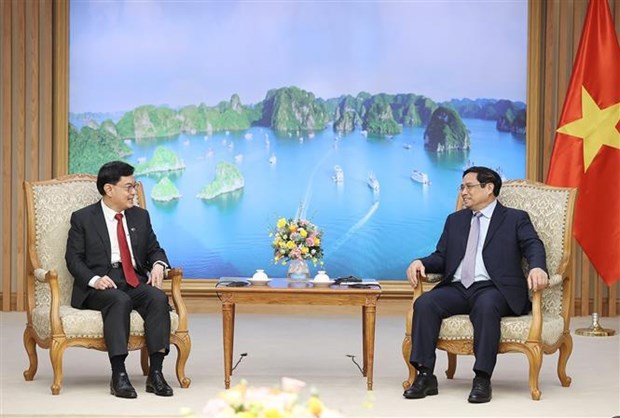 越南政府总理范明政会见新加坡副总理王瑞杰 hinh anh 1